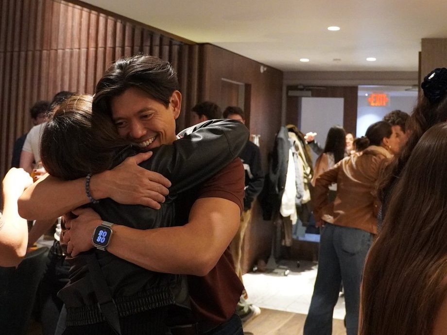 Two people hugging at an Oyster gathering
